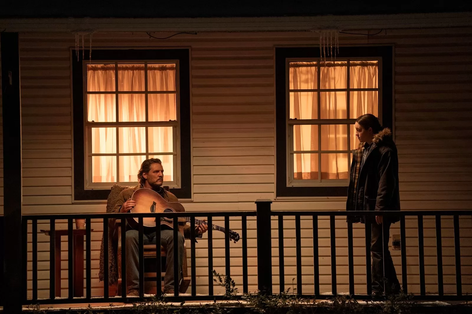 Image may contain Pedro Pascal Adult Person Railing Handrail Lighting Chair and Furniture