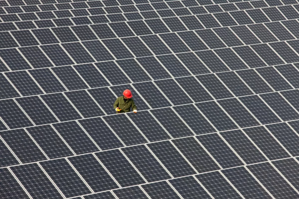 Man inspecting solar panels.