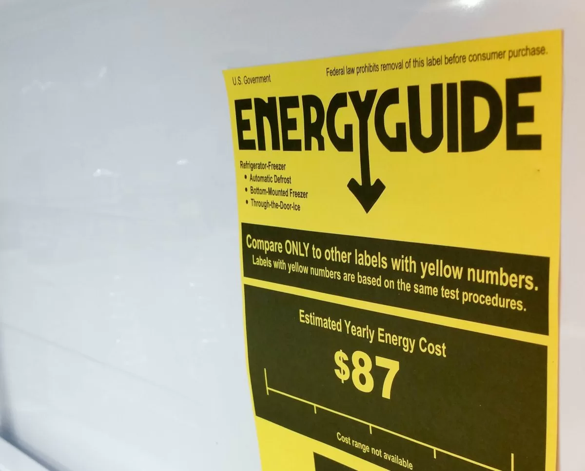 A yellow EnergyGuide label displayed inside a refrigerator.
