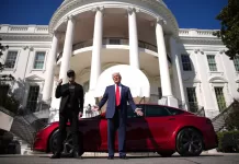 U.S. President Donald Trump and White House Senior Advisor, Tesla and SpaceX CEO Elon Musk deliver remarks next to a Tesla Model S on the South Lawn of the White House on March 11, 2025 in Washington, DC.