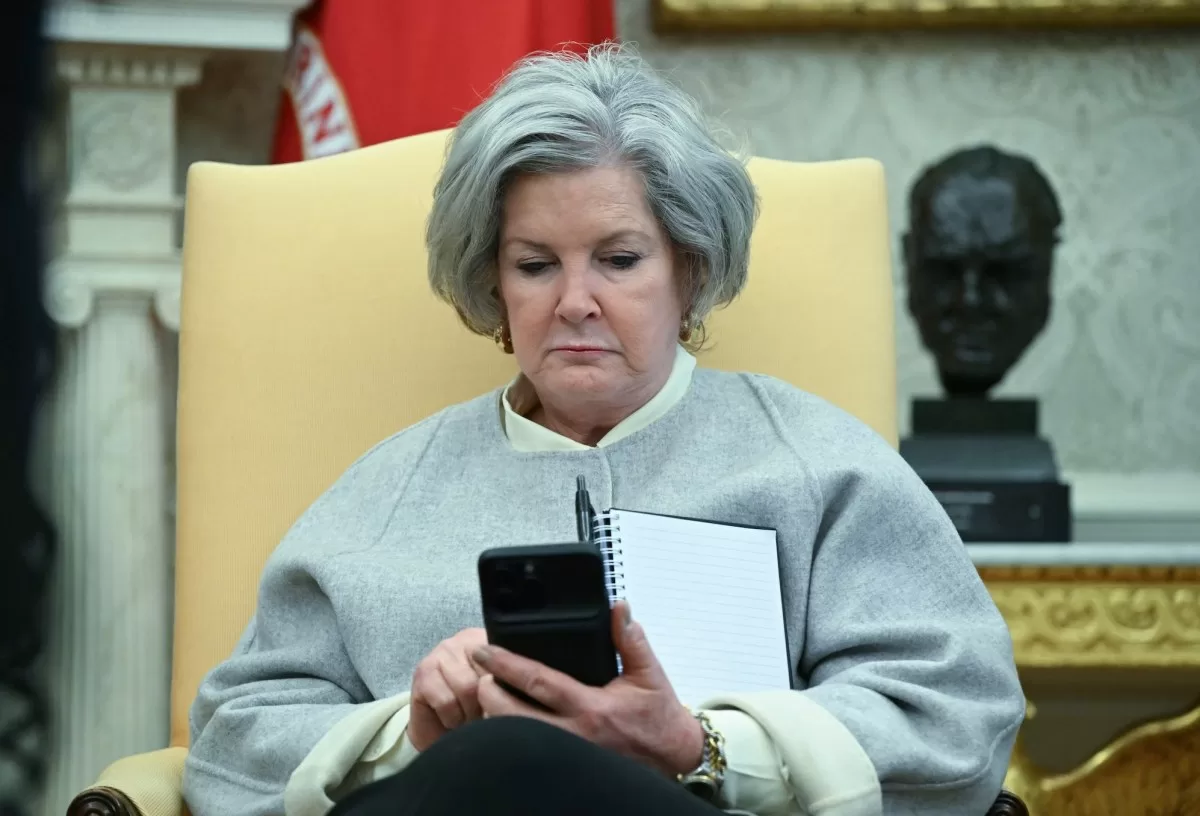 White House chief of staff Susie Wiles looks at her phone as US President Donald Trump speaks in the Oval Office of the White House