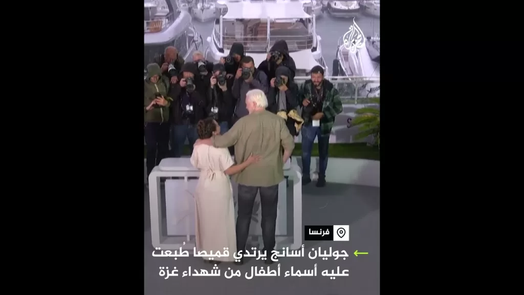 جوليان أسانج يرتدي قميصا بأسماء أطفال من شهداء  غزة