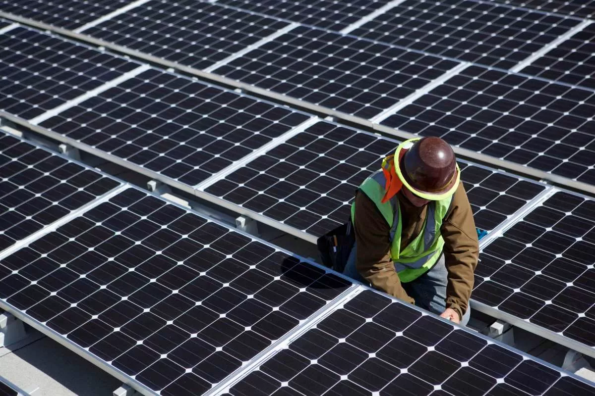 A man inspects solar panels.