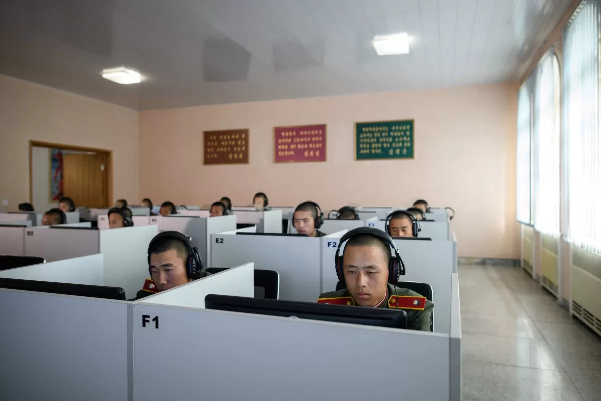 Students wearing Korean People's Army (KPA) uniforms sit before computer screens as they attend a class at the Mangyongdae Revolutionary School outside Pyongyang.