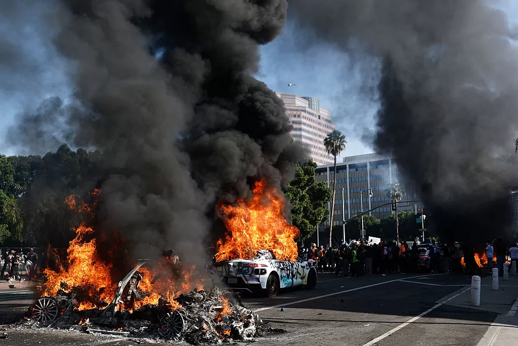Waymo cars burn during immigration raid protests on June 08, 2025 in Los Angeles, California. Tensions in the city remain high after the Trump administration called in the National Guard against the wishes of city leaders following two days of clashes with police during a series of immigration raids.