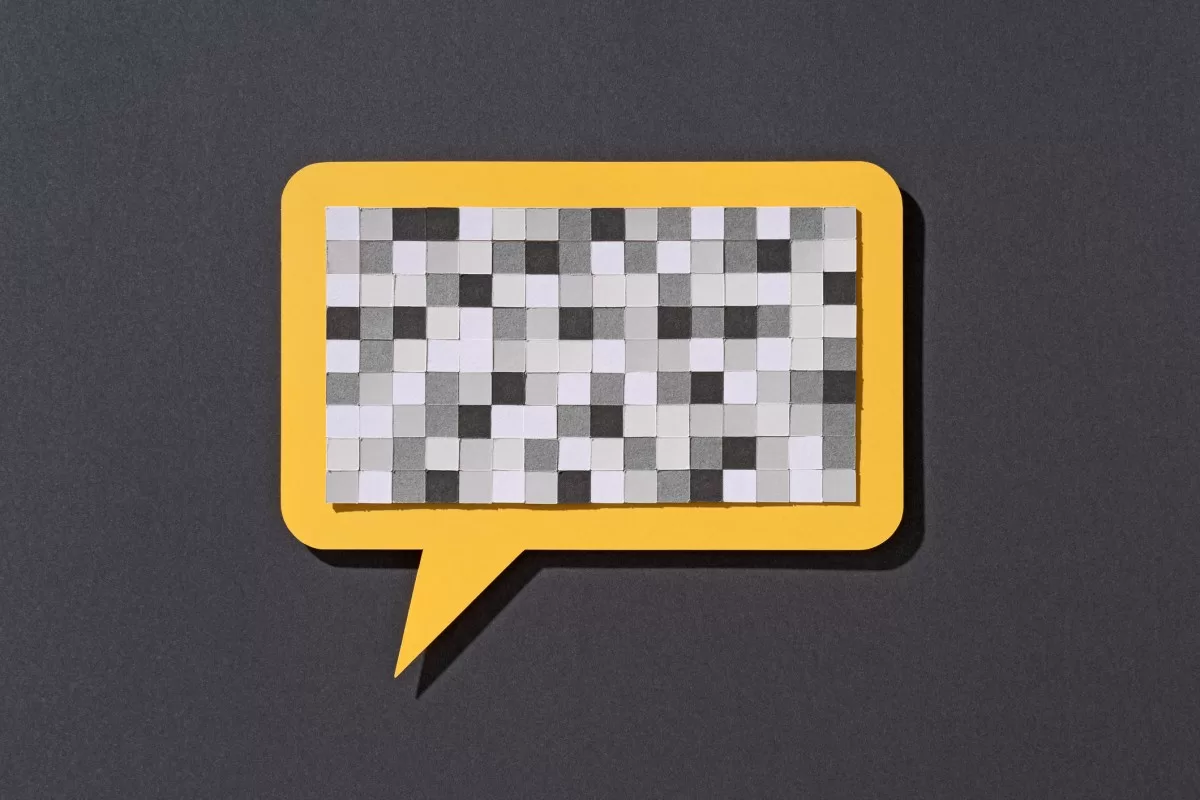 Paper Craft Pixel Mosaic Covering a Yellow Speech Bubble on Gray Background Front View, Censorship Concept.