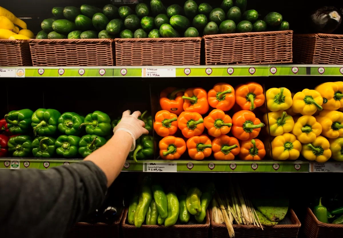 a file photo of a Whole Foods store shelf featuring fresh vegetables and bell peppers.