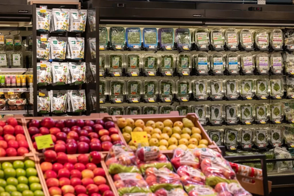 a selection of food items on a store shelf at Whole Foods