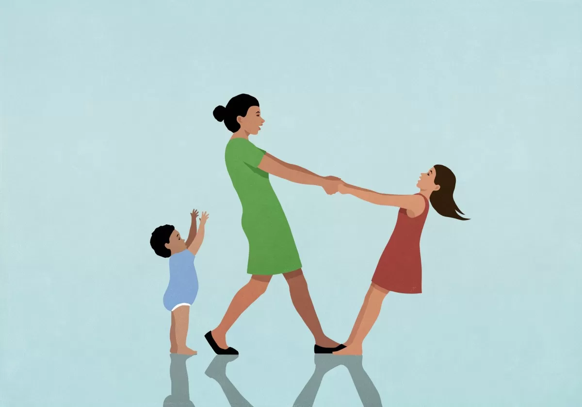 Happy, carefree mother playing with daughter and baby son