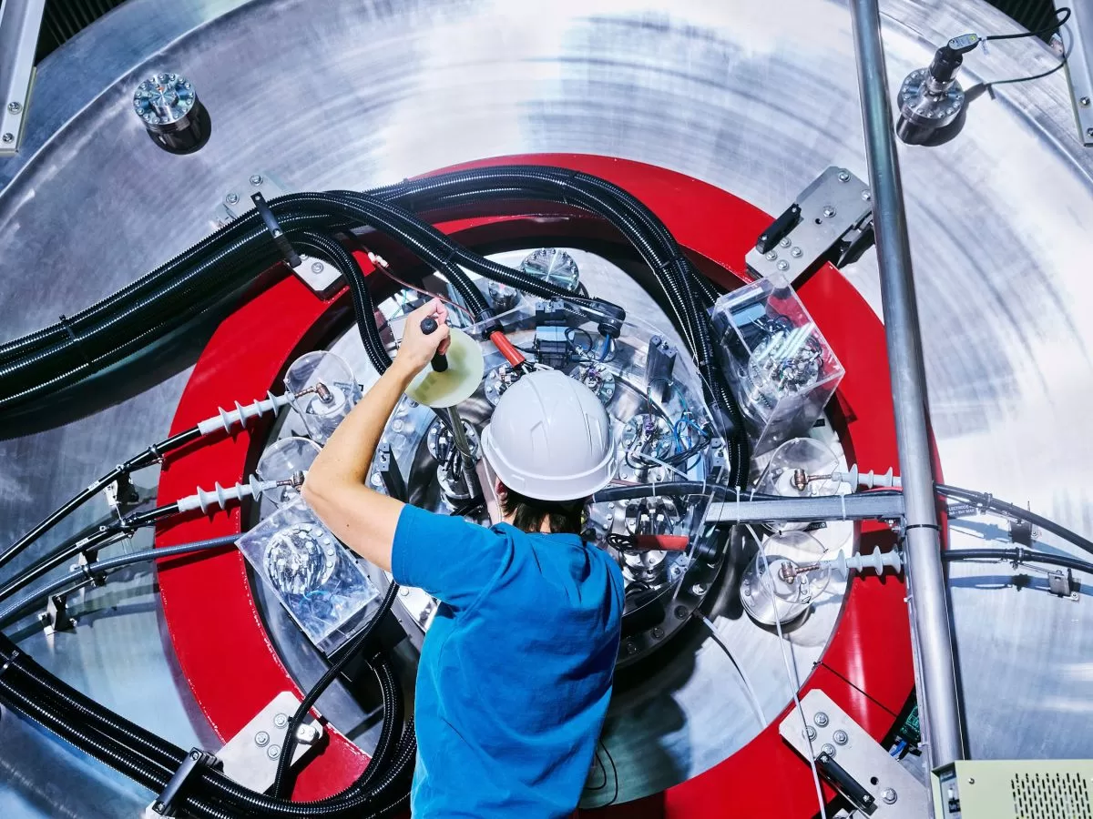 An employee is seen working on TAE Technologies’ fusion energy research device.