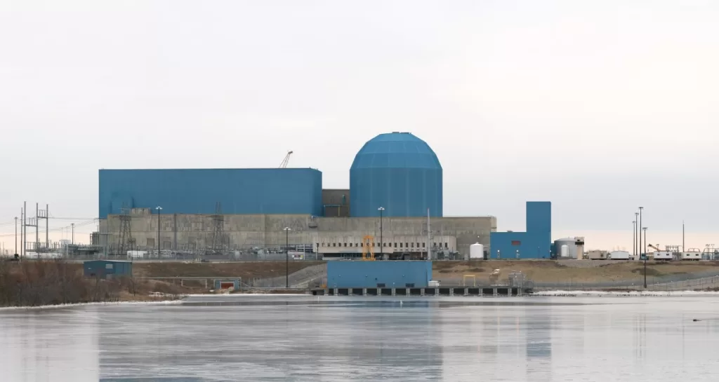The Clinton Clean Energy Center stands before a frozen lake.