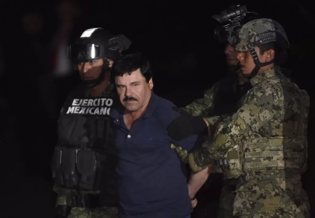 Drug kingpin Joaquin "El Chapo" Guzman is escorted by marines to a helicopter at Mexico City's airport on January 8, 2016 following his recapture during an intense military operation in Los Mochis, in Sinaloa State.
