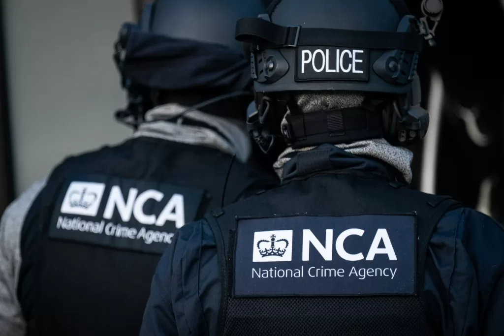 Officers from the National Crime Agency arrive at a property of a man who is accused of being a member of a group arranging small boat crossings and HGV journeys for migrants, in Grays , Essex.