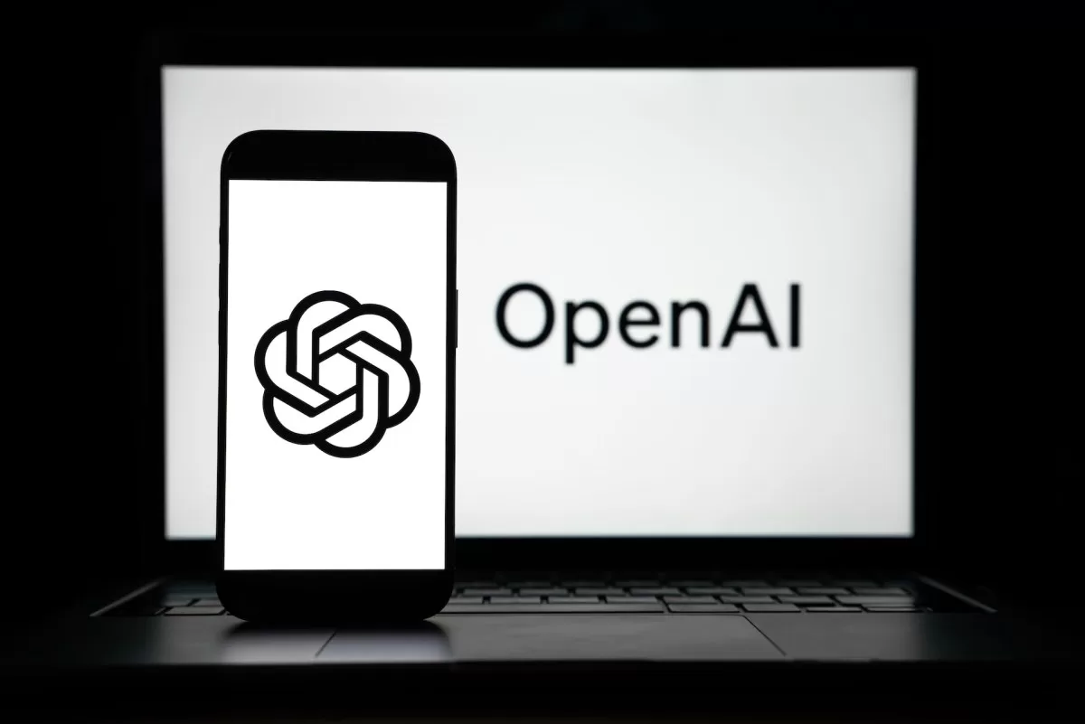 the logos of Open AI displayed on both computer and smart phone screen