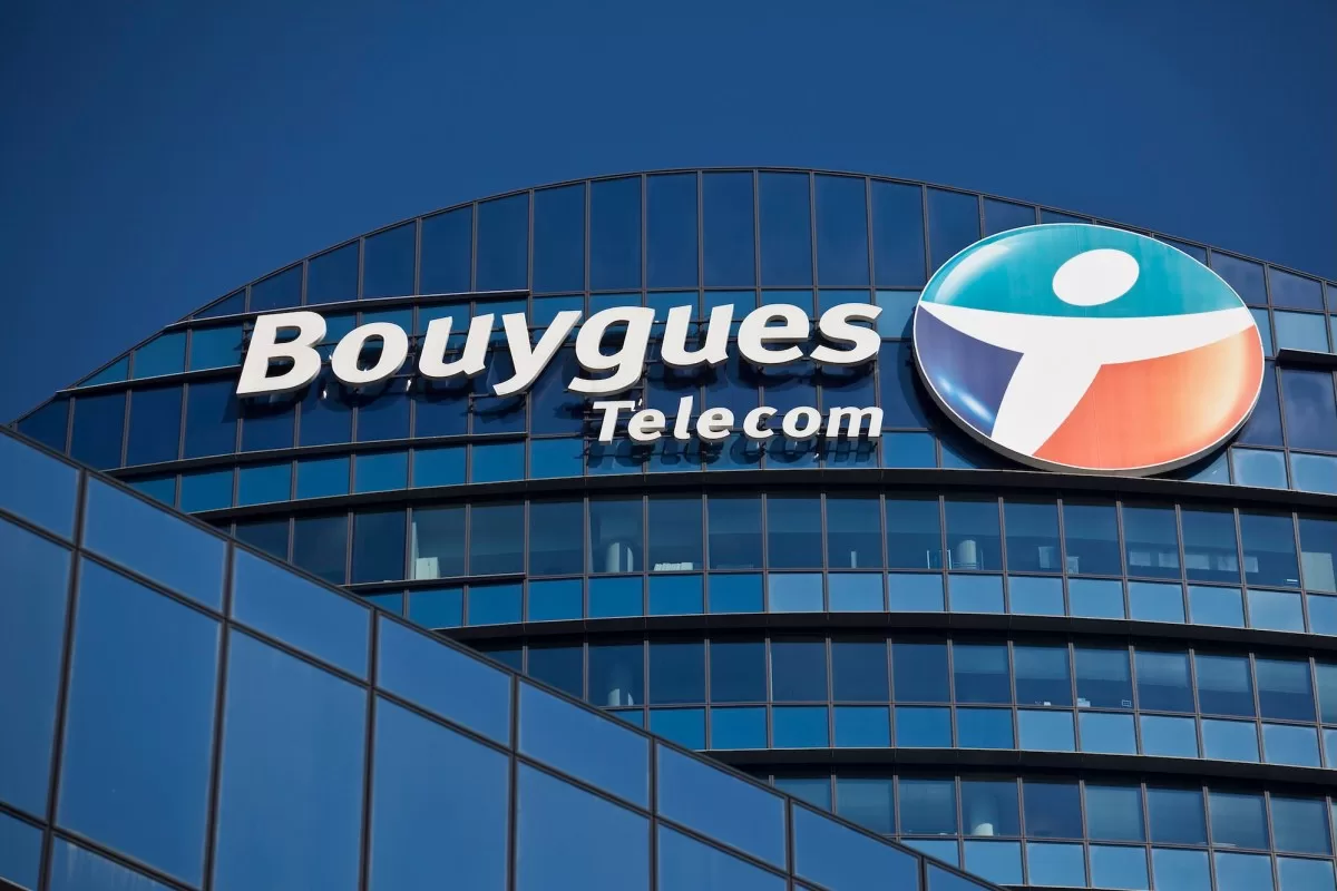 a logo outside the headquarters of Bouygues Telecom, against a blue sky background