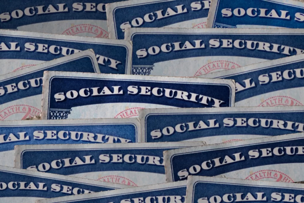 a selection of Social Security cards on a darkened background