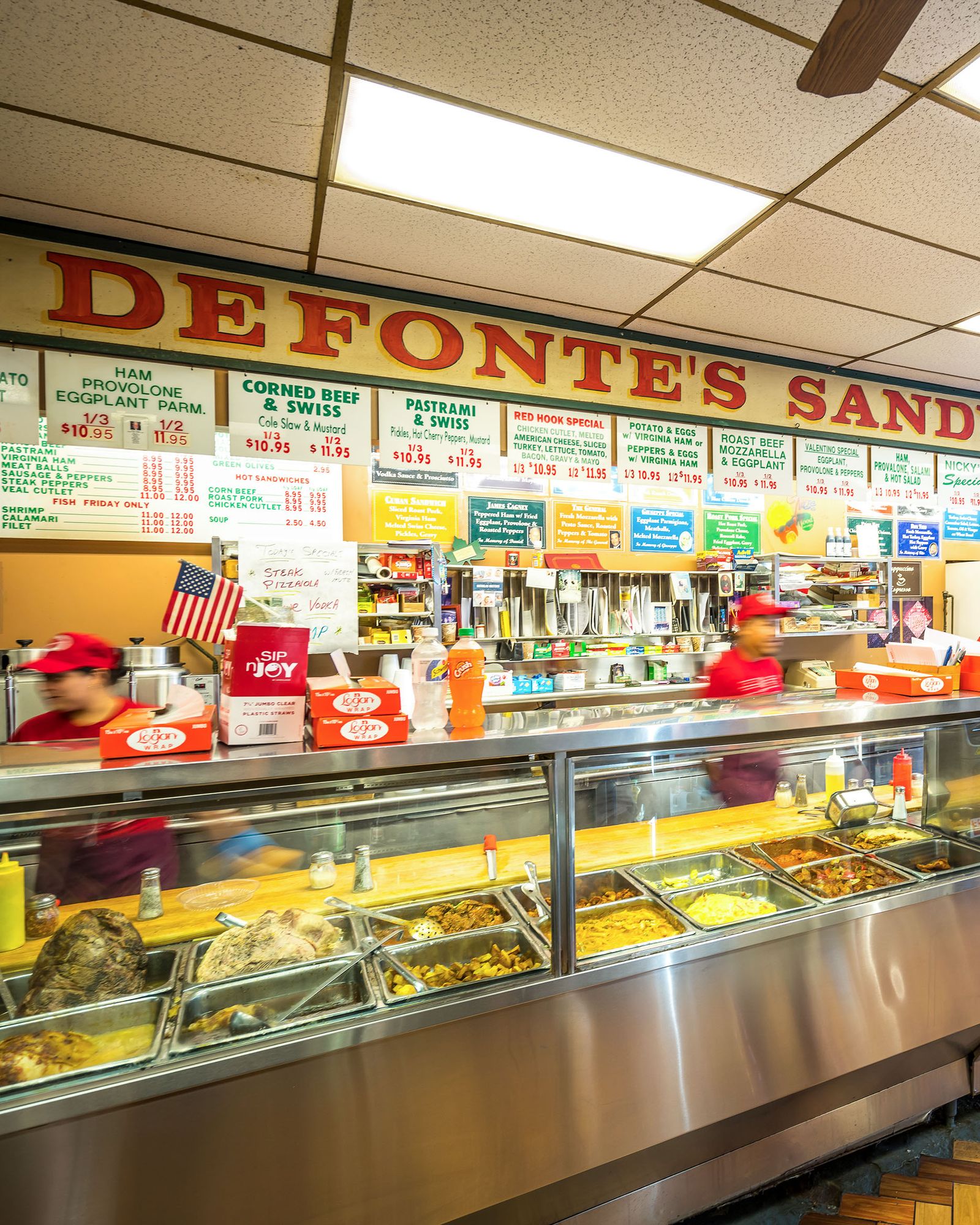 Customers ordering at the counter in Defonte's Sandwich Shop