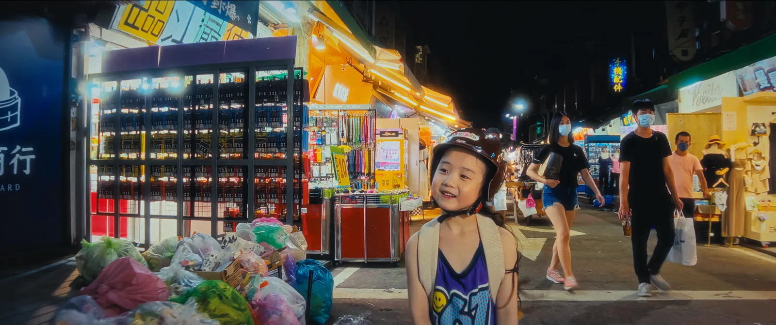 Image may contain Urban City Child Person Road Street Night Life Face Head Photography Portrait and Helmet