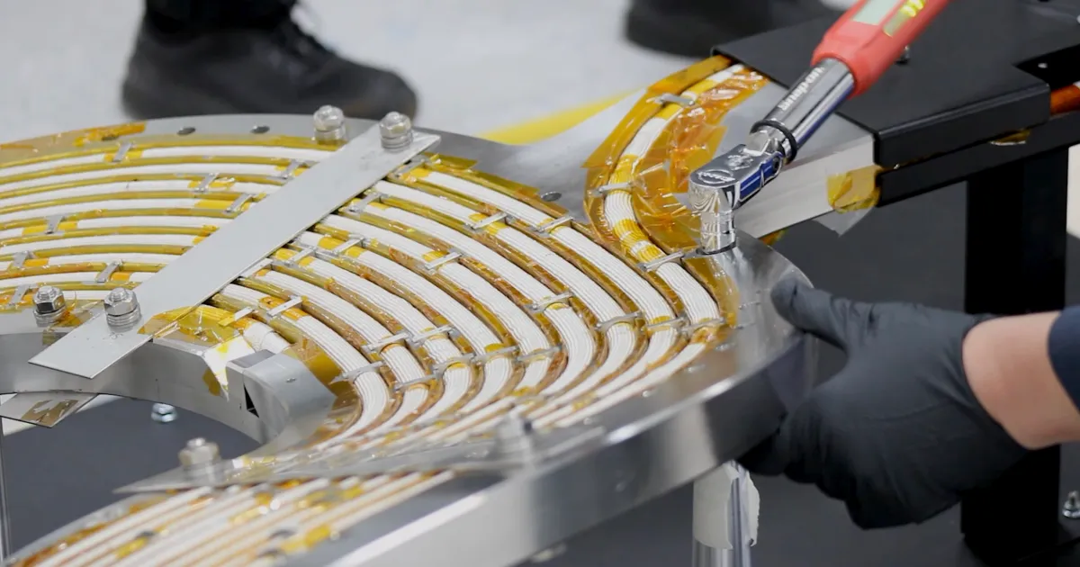 An engineer works on a high-temperature superconducting magnet.