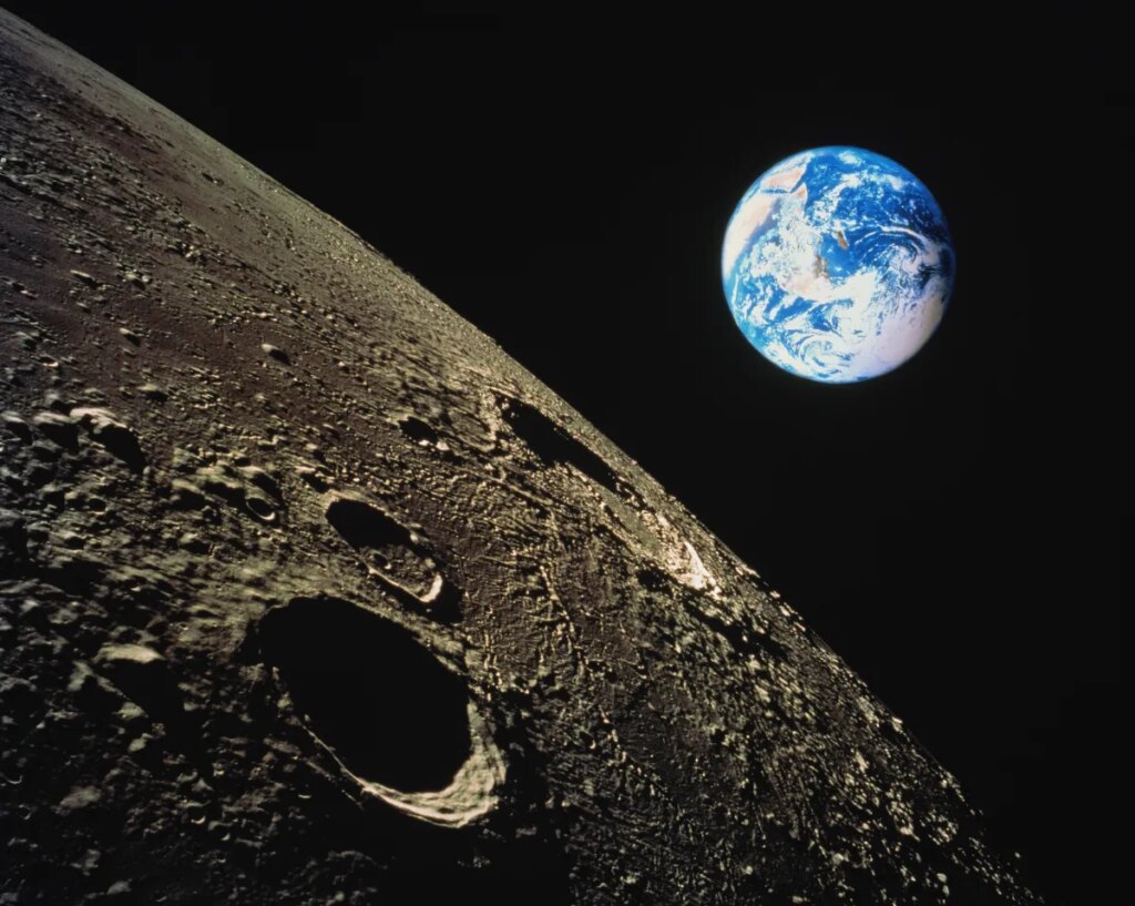 view of Earth with moon surface in foreground