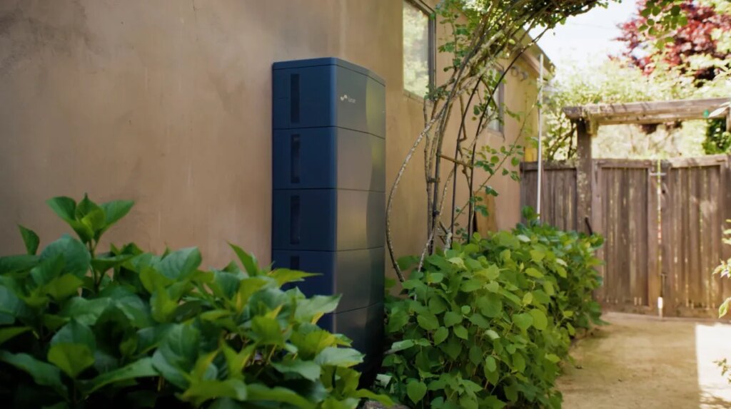 A stationary battery is attached to a home.