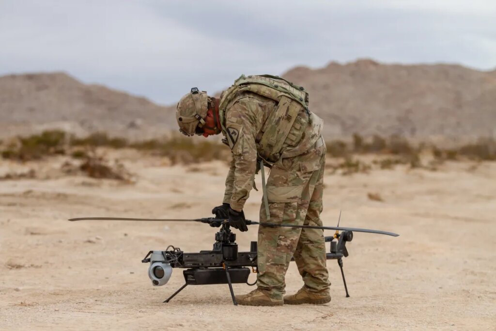 A US soldier prepares an Anduril-built drone for flight during a training exercise.