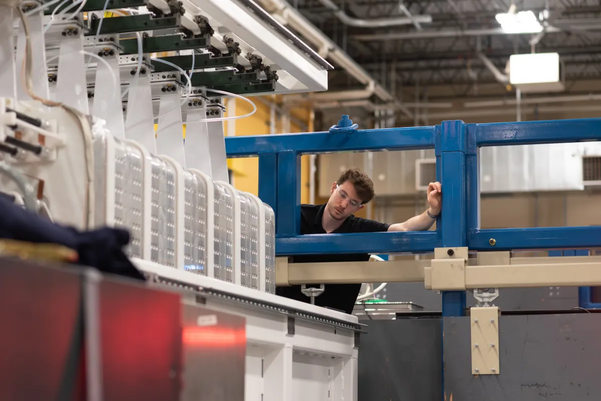 A man inspects a laser system.