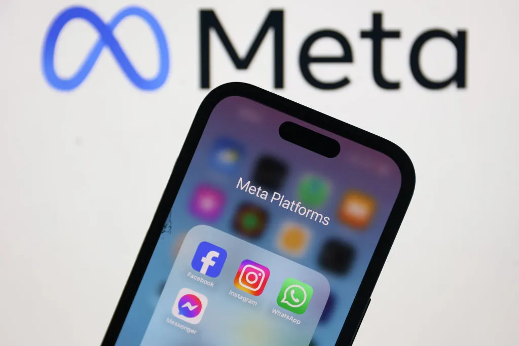 Meta logo displayed on a laptop screen and Facebook, Instagram, WhatsApp and Messenger icons displayed on a phone screen are seen in this illustration photo.